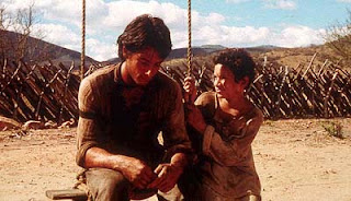 Tonio and Pacu sitting together in the dirt, from Behind the Sun