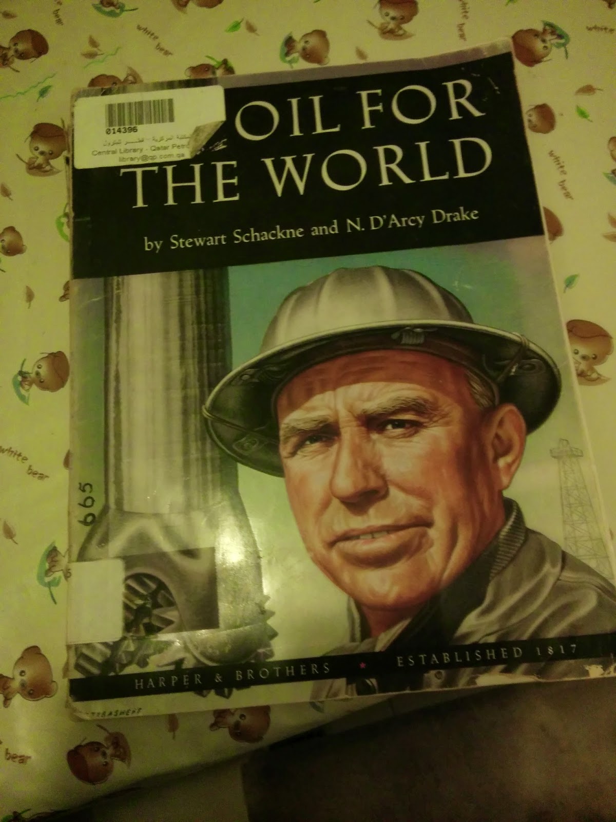 A library copy of Oil for the World by Stewart Schackne and N. D’Arcy Drake, still carrying its Qatar Petroleum barcode
